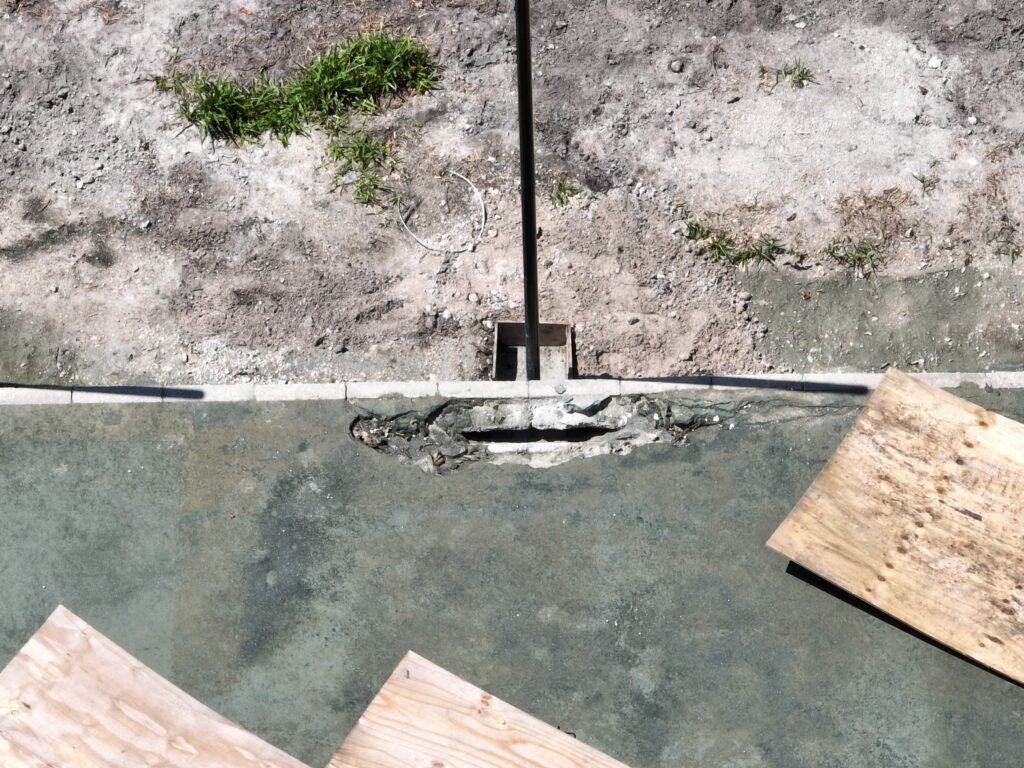 Concrete being smoothed with a power trowel on a construction site.