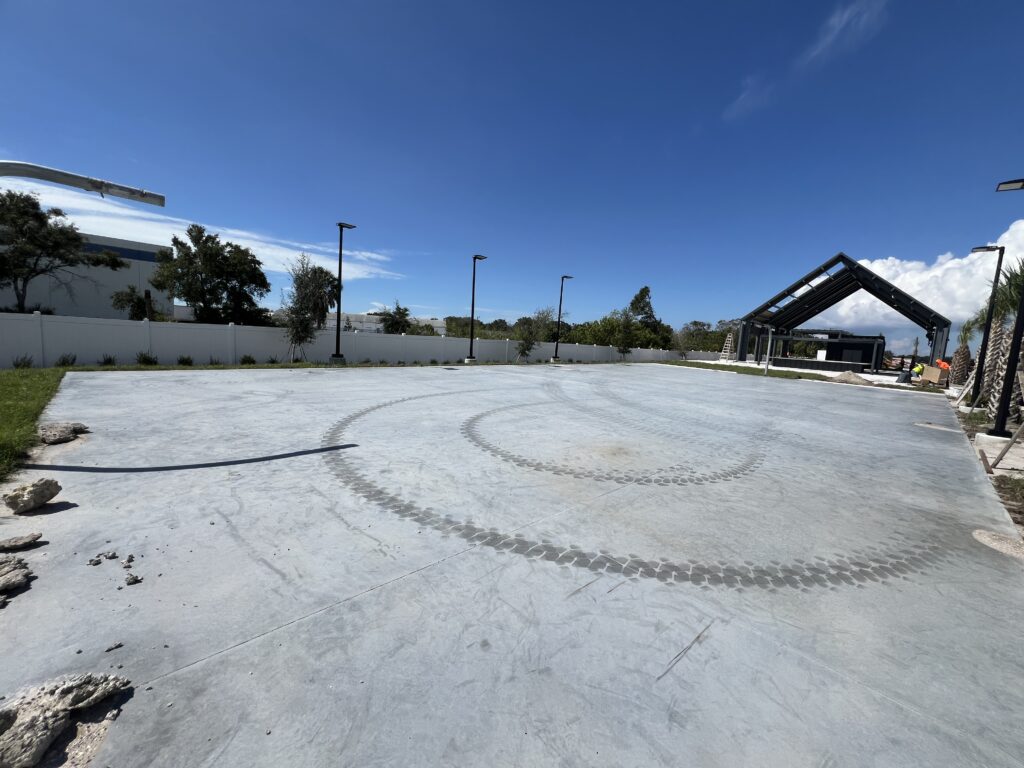 Empty circular concrete area under a clear blue sky.