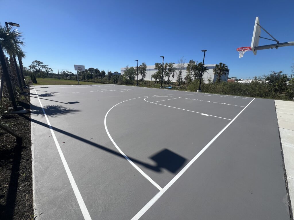 Empty outdoor basketball court on a sunny day.