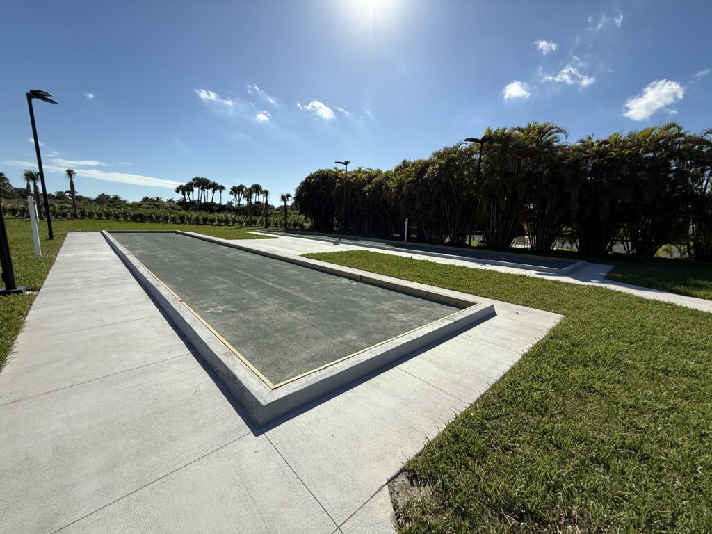 Modern rectangular reflecting pool under a bright sky.