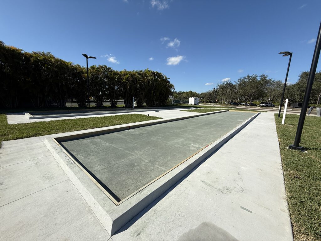 Empty bocce ball court on a sunny day with clear skies.